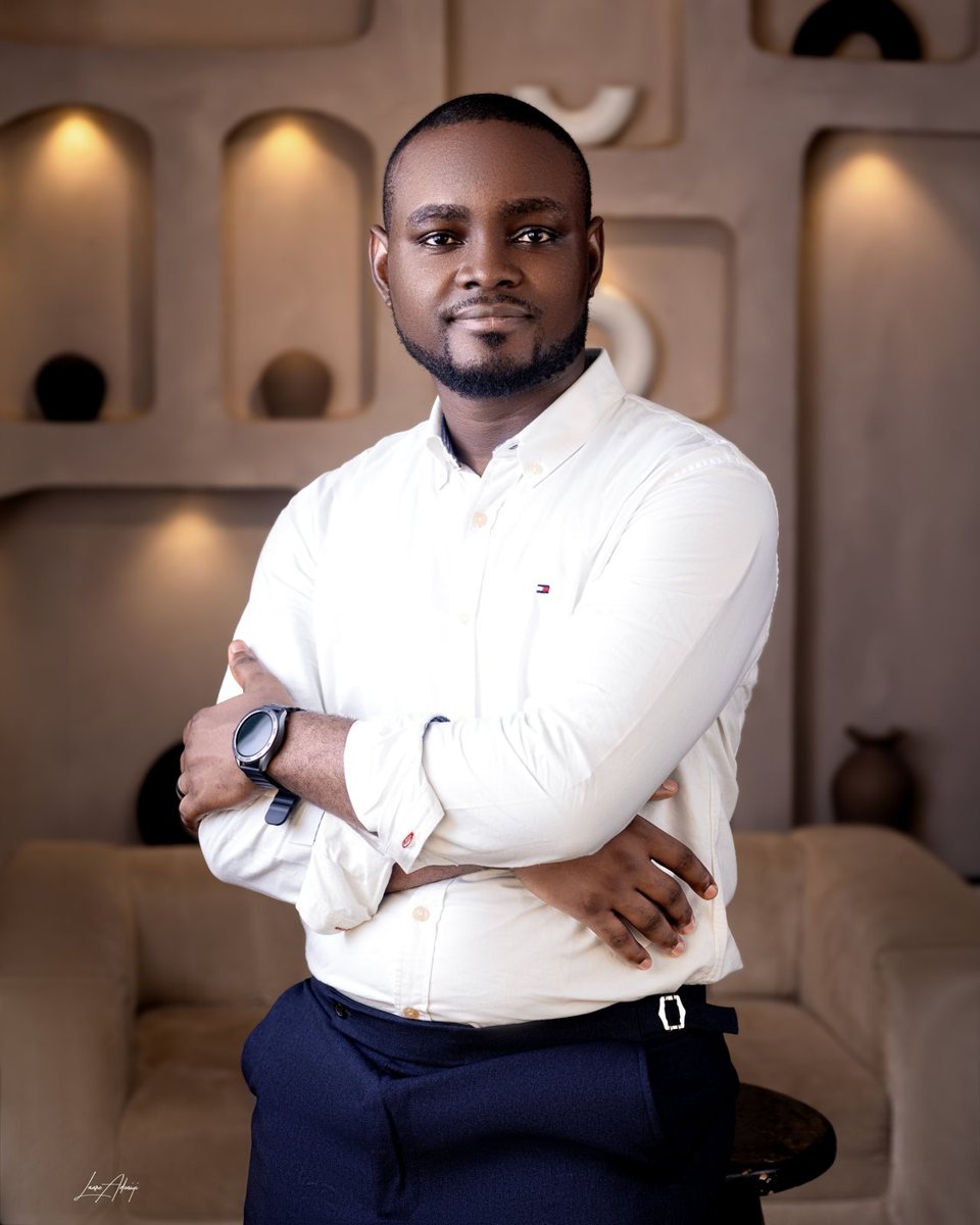 Samuel Komolafe seated at desk reviewing digital system workflows